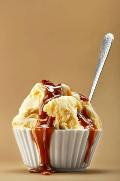 istock Ice cream sundae in white bowl isolated on a warm background. Copy space 1209927857