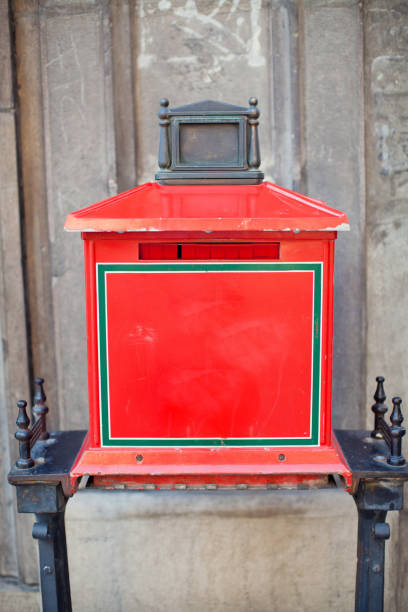 istock Vintage red mailbox on a background of stone wall 1209929180