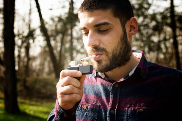 istock Man smoking cigar in nature 1209930329