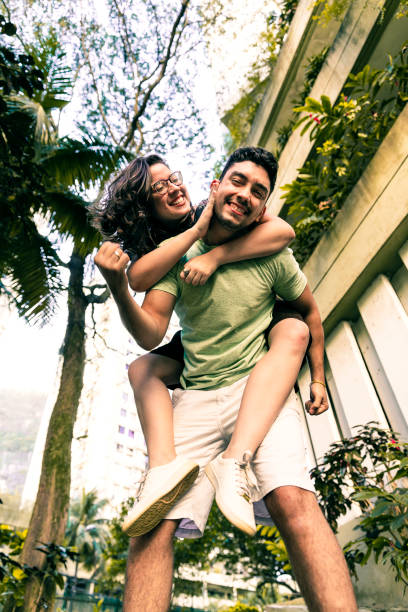 istock Young man playfully piggybacking his young friend 1209930533