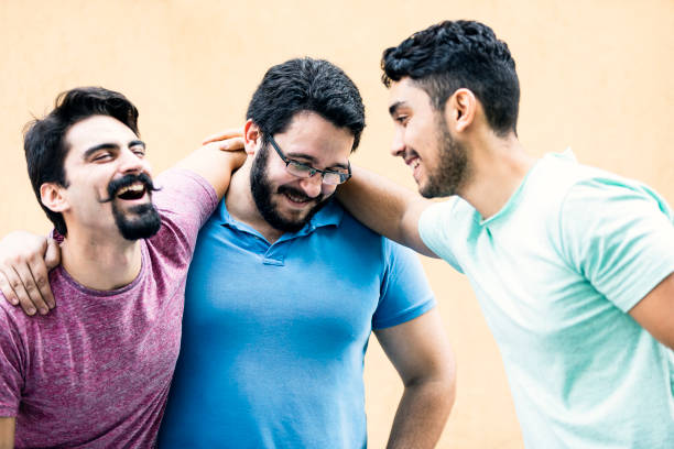 istock Young male friends laughing and embracing 1209930752