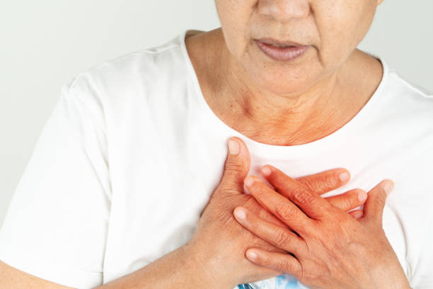 istock Old woman heart attack holding breast on white background 1209930957