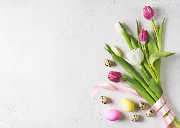 istock Tulips easter flat lay with pink and white flowers and eggs on white background 1209931768