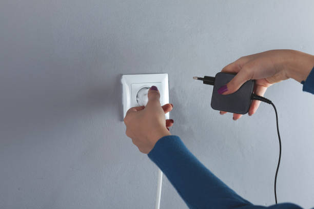 istock A woman hand pulls a black cord in home 1209932239