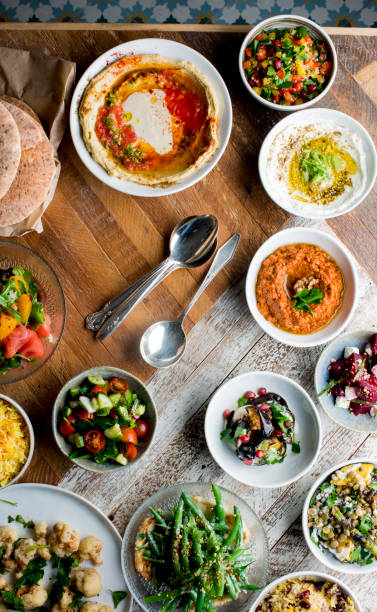 istock Spreads and Dips served at a Greek or Turkish table setting. An  assortment of traditional classic dishes being served. Hummus, Tzatziki, Olive Tapenade, fresh tomatoes cucumbers olive oil lemon dill with hot homemade pita bread. 1209932801