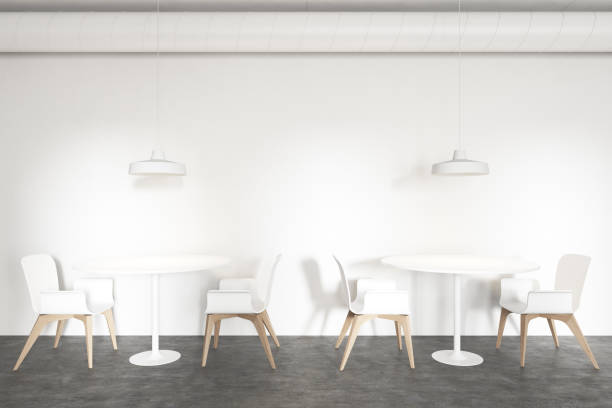 istock Tables in stylish white industrial style cafe 1209932914