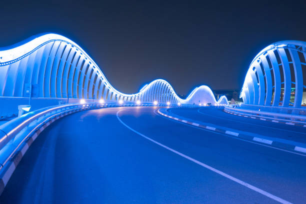 Meydan Bridge and street road or path way on highway with modern architecture buildings in Dubai Downtown at night, urban city at night, United Arab Emirates or UAE. Meydan Bridge and street road or path way on highway with modern architecture buildings in Dubai Downtown at night, urban city at night, United Arab Emirates or UAE. khalifa stock pictures, royalty-free photos & images