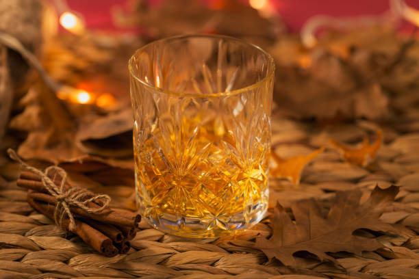 istock Whiskey, brandy or liquor, spices and decorations on dark background 1209933408