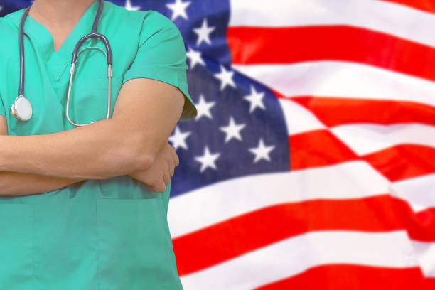 man surgeon or doctor with stethoscope on the background of the united states of america flag. health care, surgery and medical concept in us. - government flag american culture technology imagens e fotografias de stock