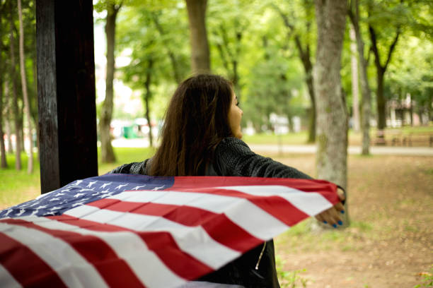 istock Beautiful young woman with USA flag 1209934262