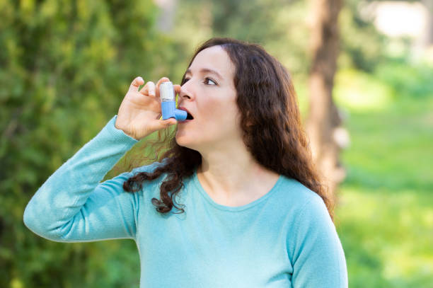 istock Woman using an asthma inhale 1209935084