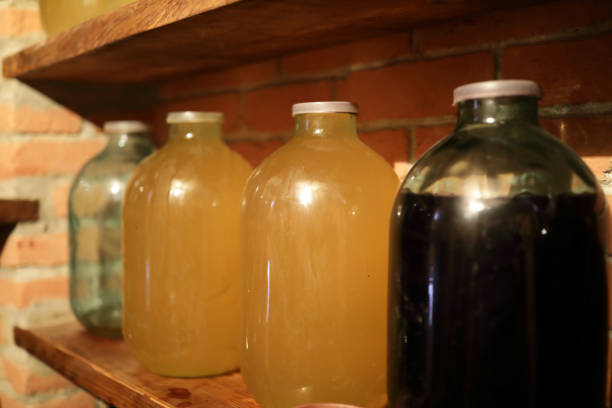 istock Wine in glass jars on shelf 1209937458