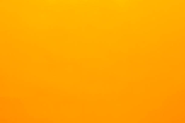 istock Yellow background made of real colored paper, illuminated by a soft light from above. 1209940692