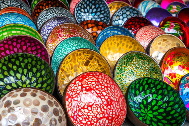 Hand crafted lacquer painted traditional Vietnamese bowls, made from coconut shells, for sale in a market Hoi An, Vietnam, Asia