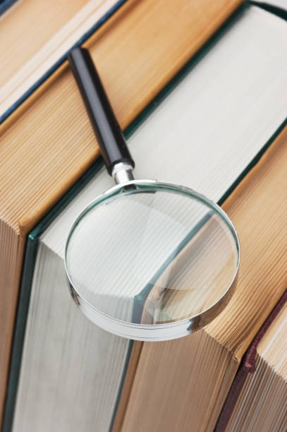 istock books and magnifying glass 1209940902