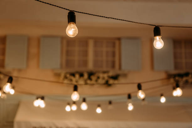 istock light bulbs retro garland outside house wall 1209941586