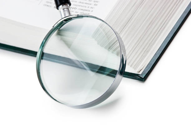 istock books and magnifying glass 1209941592