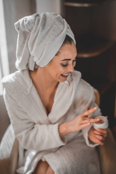 istock Woman Applying Moisturizer To Her Face 1209941779
