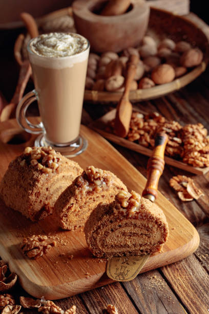 istock Walnut cake and coffee latte with cream on a wooden table. 1209943613
