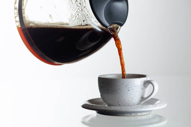 istock Coffee is poured from the coffee maker into a cup. 1209944556