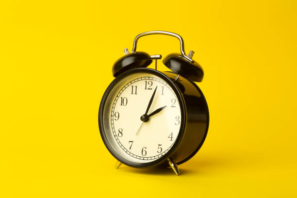istock Time background concept. Vintage classic alarm clock on yellow empty background. Time management comcept 1209944938