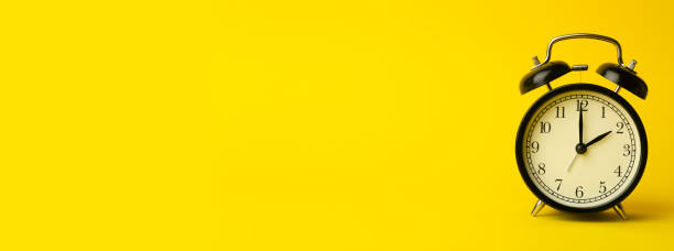 istock Time background concept. Vintage classic alarm clock on yellow empty background. Time management comcept 1209944942