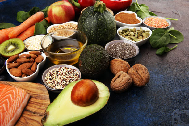 istock Healthy food clean eating selection: fish, fruit, vegetable, cereal, leaf vegetable on rustic background 1209945393