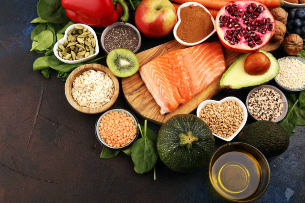 istock Healthy food clean eating selection: fish, fruit, vegetable, cereal, leaf vegetable on rustic background 1209946097