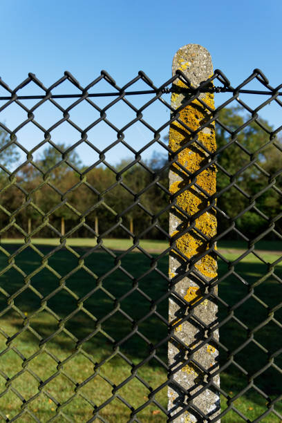 istock Chain link fence on concrete post. 1209946127