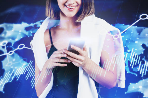 istock Smiling woman with smartphone, world map 1209946272