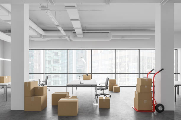 Boxes in new open space office, relocation Cardboard boxes with equipment in spacious white Industrial style open space office interior. Concept of moving to new place and delivery. 3d rendering company relocation stock pictures, royalty-free photos & images