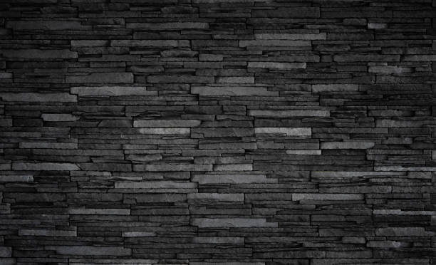 istock Texture of black brick slate wall, dark grey stone background 1209947552
