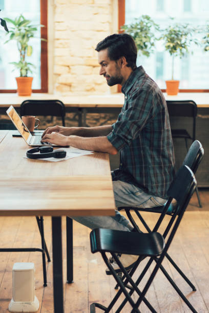 istock Enthusiastic man working alone at daytime stock photo 1209950819