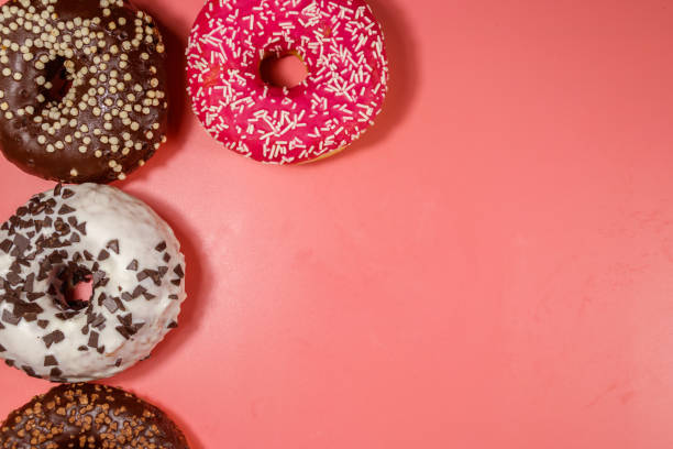 istock Tasty donuts on pink background. Top view, copy space 1209950851