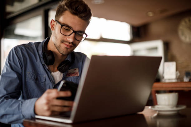 istock Young man working in coffee shop 1209952737