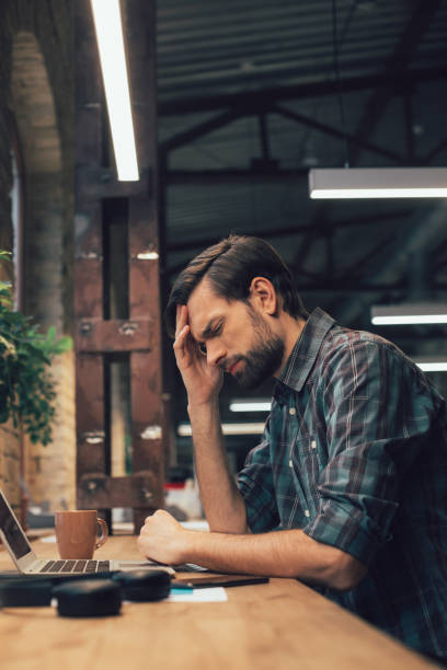istock Office worker having headache at work stock photo 1209953391