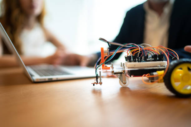 istock Business partners working with prototype of drive robotic car 1209954054