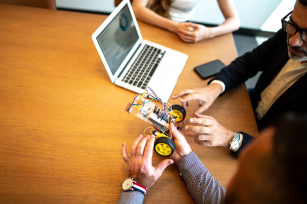 Business partners working with prototype of drive robotic car