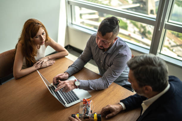 istock Business partners working with prototype of drive robotic car 1209955749