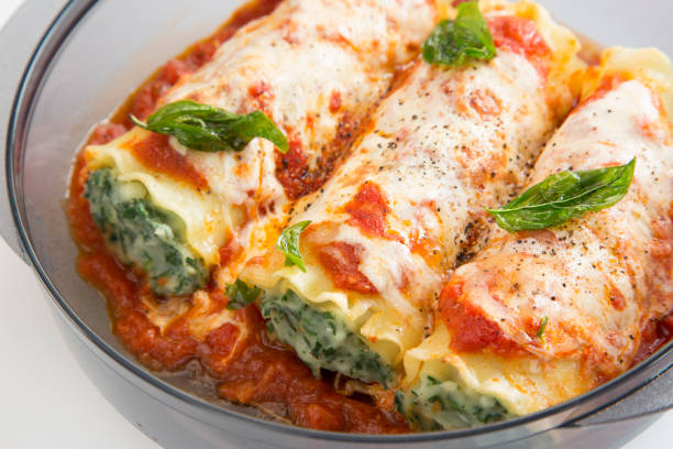 cannelloni Cannelloni filled with ricotta cheese and spinach into a transparent glass bowl ricotta photos stock pictures, royalty-free photos & images