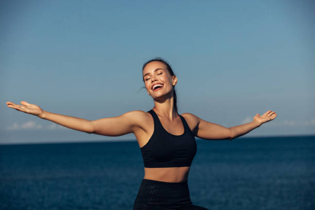 istock Young woman meditating outdoors 1209955983