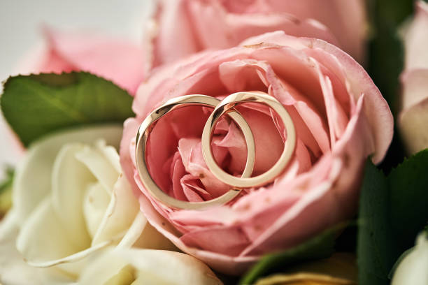 istock wedding rings lie on the bouquet 1209956803
