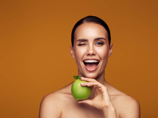 istock Woman eat green apple 1209957115