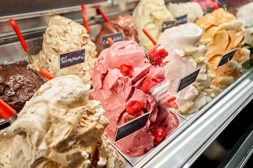 Fruit with strawberries Gelato. Flavors various ice cream in Rome, Italy. Italian gelateria. Assortment of colorful gelato on cafe showcase. Natural fresh ice cream