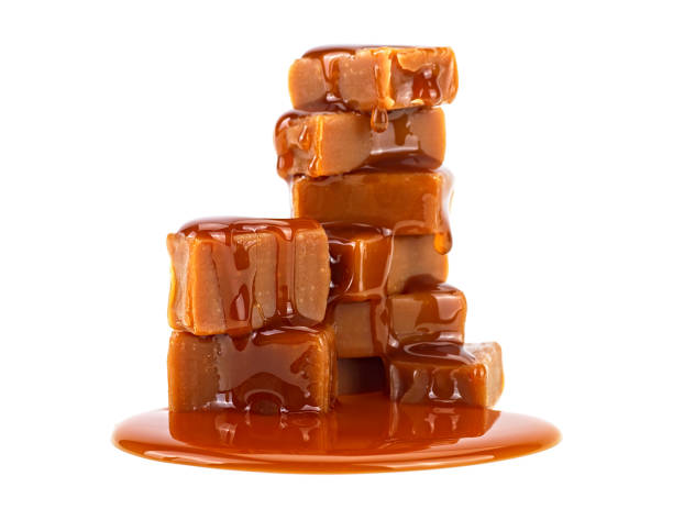 istock Caramel candies and caramel sauce isolated on a white background 1209958455