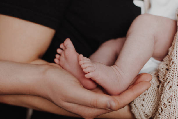 istock Parents hands holding baby feet 1209958531