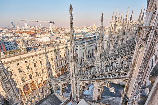 Amazing view of old Gothic spires. Milan Cathedral roof on sunny day, Italy. Milan Cathedral or Duomo di Milano is top tourist attraction of Milan