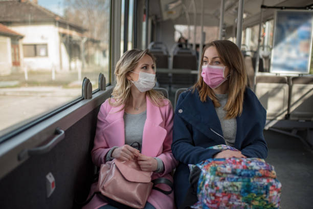istock Two women at public transport during virus epidemic 1209960106