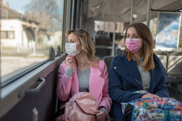 istock Two women at public transport during virus epidemic 1209960114