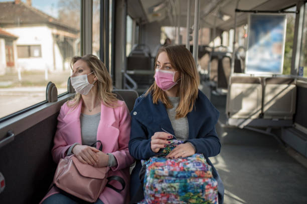 istock Two women at public transport during virus epidemic 1209960131